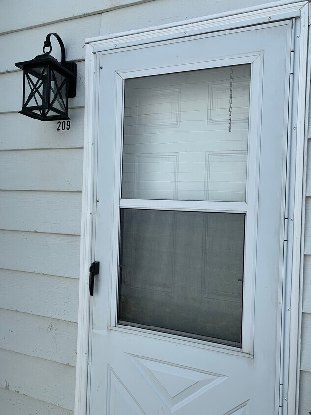 Private entrance off of the patio with energy-efficient door, as well as storm door - 209 30th Street Dr SE