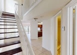 Located at 12325 SW 151st St in Miami, FL, this two-story home offers a thoughtfully designed layout across two levels. The main floor welcomes you with light-toned ceramic tile flooring that flows throughout the open living and dining areas. Large windows and a sliding glass door invite abundant natural light and provide views of the surrounding greenery. A ceiling fan in the living area adds a practical touch to the airy, open feel of the space.

The kitchen is outfitted with rich dark wood cabinetry, granite countertops, black appliances including a refrigerator and electric range, and tile flooring, offering both functionality and visual contrast. A convenient half bathroom with a granite-topped vanity is also located on the main level.

A staircase with dark wood treads and a white balustrade leads to the upper floor, which features a landing overlooking the main living area below — adding a sense of vertical openness to the home. Upstairs, carpeted bedrooms provide a softer, more comfortable feel, with windows framing lush outdoor views. The upper-level bathroom includes a granite vanity with rich wood cabinetry, a tub-shower combination with tile surround, and stylish brushed nickel fixtures. Throughout, the home maintains a clean, neutral palette that enhances its bright and welcoming ambiance.