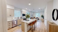 Located at 6021 Lakewood Dr W in University Place, WA, this thoughtfully designed one-bedroom, one-bathroom residence offers a modern aesthetic with clean lines and high-quality finishes throughout. The open-concept layout seamlessly connects the kitchen, dining, and living areas, creating an airy and functional flow. The kitchen is a standout feature, outfitted with light wood cabinetry, white quartz countertops, stainless steel appliances, a subway tile backsplash, and a central island with bar seating — ideal for both cooking and casual dining. Light wood-style flooring runs throughout, enhancing the bright, contemporary feel. The living area is bathed in natural light from multiple windows with adjustable blinds and is equipped with a wall-mounted mini-split system for year-round comfort. The bedroom is a calm, well-proportioned retreat with a large window and direct views into the open living space. The bathroom features light wood vanity cabinetry, a white countertop, and a full tub-shower combination with black hardware accents. Additional highlights include in-unit laundry and three closets providing ample storage throughout the residence.