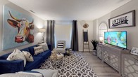 This single-floor residence offers a thoughtfully designed layout that balances functionality and style across its key living spaces. The galley-style kitchen is a standout feature, lined on both sides with white shaker cabinetry that extends to the ceiling, providing generous storage. Granite countertops with bold veining complement the stainless steel sink, while black appliances—including a range and full-size refrigerator—anchor the space. Light wood-look flooring runs through the kitchen, adding warmth to the neutral palette.

The living area is generously proportioned, featuring the same wood-look flooring and a textured ceiling. A large window fitted with vertical blinds and drape panels allows for adjustable natural light, contributing to the room's bright, open feel. Neutral wall tones throughout the residence create a cohesive backdrop across all spaces.

The bedroom is finished with plush carpet and features a sliding double-door closet offering practical storage. A window with blinds brings in natural light, while the textured ceiling and soft tones lend a calm, restful atmosphere. The bathroom is accessible via a short hallway, featuring wood-look flooring, neutral walls, and clean white fixtures, completing this efficiently designed residence.