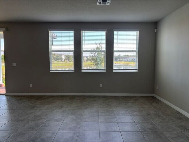 Foto del edificio - Like-New 4 Bedroom 3 Bath with Pond View & Two Living Spaces — Minutes to South Lake Nona