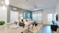 Located at 1911 Waterway Cir in Middleburg, FL, this well-appointed 3-bedroom, 2-bathroom residence offers a thoughtfully designed single-floor layout with modern finishes throughout. Wood-look luxury vinyl flooring flows seamlessly across every room, creating a cohesive and contemporary aesthetic.

The open-concept kitchen and living area serves as the heart of the home. The kitchen features crisp white cabinetry, stainless steel appliances, a large center island with pendant lighting and bar seating, and light quartz-style countertops. An in-unit washer and dryer is conveniently tucked nearby. The adjacent living room is bright and inviting, with large windows that allow abundant natural light, a ceiling fan, and a signature sage green accent wall that adds warmth and character.

The spacious primary bedroom features a bold navy accent wall, ceiling fan, and generous natural light from oversized windows. It connects to a dedicated walk-in closet outfitted with wire shelving and hanging storage. Two additional bedrooms provide flexible space for guests or a home office.

Both bathrooms are finished with white cabinetry, neutral countertops, and clean tilework. One bathroom includes a soaking tub with a curved curtain rod and stylish wood-look flooring. The overall ambiance throughout the residence is clean, modern, and move-in ready.