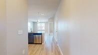 Located in Richmond, TX, this single-floor 2-bedroom, 2-bathroom residence offers a thoughtfully designed layout with modern finishes throughout. The open-concept kitchen and living area serves as the heart of the home, showcasing a large granite-topped island with pendant lighting, stainless steel appliances, and crisp white cabinetry complemented by dark accent cabinets. Light wood-tone flooring flows seamlessly through the main living areas, creating a bright and cohesive aesthetic.

Both bedrooms are well-proportioned and filled with natural light from dual windows fitted with blinds. Ceiling fans provide comfort in each room, while soft carpet underfoot adds warmth. Each bedroom is paired with its own dedicated closet, both outfitted with built-in shelving and hanging rods for efficient storage.

The primary bathroom is especially spacious, featuring a dual-sink granite vanity with gray cabinetry, framed mirrors, and light wood flooring. The second bathroom offers a similarly refined look with a single granite vanity and a tall storage cabinet. Both bathrooms are finished with polished chrome fixtures for a clean, contemporary feel.

The neutral warm-gray color palette used throughout the residence creates a calm, cohesive ambiance, making every room feel inviting and move-in ready.