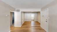 Located at 203 Forest Pine Rd in Franklin, Virginia, this two-bedroom, one-bathroom single-story home offers a practical and well-organized layout. The open living and dining areas are finished with warm wood-look flooring and neutral-toned walls, creating a bright and cohesive space. Natural light filters in through large windows, enhancing the clean, airy atmosphere throughout. The living room flows naturally toward the dining area and into a refreshed kitchen, which features crisp white cabinetry, marble-look countertops, a stainless steel refrigerator, a built-in dishwasher, and a window above the sink that lets in additional natural light. The primary bedroom is generously sized and carpeted for comfort, offering two closets — including a spacious double-door closet — and a window with views of surrounding greenery. The second bedroom also features wood-look flooring and provides a versatile space suitable for a guest room or home office. A hallway connects the bedrooms to the full bathroom, which includes a tiled tub-shower combination. Two closets throughout the home provide ample storage. The consistent use of neutral tones, updated finishes, and functional room arrangement make this a practical and move-in ready residence.