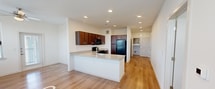 This contemporary single-floor apartment in Schertz, TX, offers a harmonious blend of comfort and functionality. The open-concept design creates a seamless flow between living spaces, enhanced by a mix of hardwood flooring in common areas and plush carpeting in bedrooms. The kitchen is a standout feature, boasting rich wooden cabinetry, granite countertops, and black appliances, including a gas range and built-in microwave.

Large windows throughout the apartment flood the rooms with natural light, while ceiling fans ensure optimal air circulation. The bathroom features a modern design with a combination tub-shower unit and ample storage. Bedrooms are spacious and well-lit, with generous closet space.

The apartment's neutral color palette, predominantly white walls, and ceilings create a bright, airy ambiance that allows for personalized decorating. Recessed lighting in the kitchen and living areas provides additional illumination. The property's attention to detail is evident in features like the stylish window blinds and modern door hardware, contributing to its overall contemporary aesthetic.