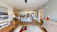 Located at 4800 N Star Ave in Panama City, Florida, this single-story residence offers a thoughtfully designed open-concept layout with modern finishes at every turn. The heart of the home is a spacious kitchen-living area where crisp white shaker cabinetry, granite countertops, a subway tile backsplash, and a full suite of stainless steel appliances create a polished, functional space. A central island with seating provides an ideal gathering point, while pendant lighting and recessed fixtures illuminate the area with warmth. Wood-look flooring flows throughout the main living spaces, connecting the kitchen seamlessly to the dining nook and the generous living room, which features a ceiling fan and access to natural light through a glass door. The bedrooms offer comfortable retreats, each with ceiling fans and plush carpeting. Accent walls — one in a rich terracotta and another in a deep teal — add bold character to the sleeping quarters. The bathrooms are equally refined, featuring granite-topped vanities with white cabinetry, wood-look tile flooring, a walk-in tiled shower in the primary bath, and a full tub-shower combo with built-in shelving in the secondary bath. Clean lines, neutral tones, and contemporary hardware tie the entire residence together into a cohesive, stylish living environment.