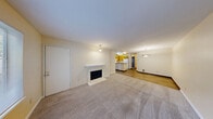 Located in Federal Way, WA, this single-floor unit offers three bedrooms, two bathrooms, and a practical, well-organized layout. The combined kitchen and living room serves as the heart of the home, where warm-toned wood cabinetry, a peninsula with granite-style countertops, and wood-look flooring define the kitchen area. White appliances, including a refrigerator and electric range, complement the functional design. The living room flows naturally from the kitchen, featuring plush carpeting, a fireplace, a pendant light fixture, and a window that brings in natural light and outdoor views. The bedrooms are carpeted and finished with warm, neutral walls. Each room is equipped with baseboard heating and windows that overlook the surrounding greenery. The primary bedroom includes closet access, providing convenient storage. Two full bathrooms serve the unit, each featuring a tub-shower combination, wood-toned vanity cabinetry, and tile-style flooring. Two closets are included throughout the unit for additional storage. The overall ambiance is warm and understated, with a consistent neutral color palette and practical finishes suited for comfortable everyday living.