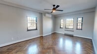 Located in Cincinnati's desirable Hyde Park neighborhood, this thoughtfully designed 2-bedroom, 1-bathroom unit blends classic architectural charm with modern updates. The space is immediately distinguished by its rich herringbone-patterned hardwood floors, which flow seamlessly throughout every room, reflecting natural light and adding a timeless elegance.

The spacious primary bedroom features dual windows, a ceiling fan with integrated lighting, a wall-mounted mini-split system for climate control, and a baseboard radiator, ensuring year-round comfort. A generous closet and classic paneled doors complete the room. The second bedroom is well-proportioned, with a large window offering views of the streetscape below and its own baseboard heating.

The hallways are a standout architectural feature, showcasing graceful arched passageways that lend a refined, classic character to the interior. The kitchen is outfitted with white shaker cabinetry, gray quartz countertops, subway tile backsplash, a matte black faucet, stainless steel dishwasher, and a window above the sink. Patterned tile flooring adds a stylish contrast to the kitchen's clean aesthetic.

The bathroom is crisp and contemporary, featuring a glass-enclosed tub-shower with white tile surround, a white vanity, and matte black fixtures and hardware throughout. Two living areas provide flexible space for entertaining or relaxing.