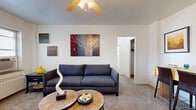 Located at 905 Jefferson St in Kansas City, MO, this one-bedroom, one-bathroom unit offers a well-organized, efficiently designed layout ideal for comfortable urban living. The inviting living room features plush carpeting, a ceiling fan with light fixture, and a bright window fitted with blinds that allows natural light to fill the space. The room provides a welcoming atmosphere with ample room for seating and a dining area nearby. The galley-style kitchen is outfitted with white cabinetry, tile backsplash, grey countertops, a stainless steel sink, and wood-look vinyl flooring, offering a clean and practical workspace. The bedroom is a comfortable retreat with carpeted floors, a ceiling fan, a natural light-admitting window, and access to closet storage. The bathroom retains a classic character with white tile surround, a tub-shower combination, a pedestal-style sink, blue mosaic tile flooring, and a window for ventilation. Two closets throughout the unit provide generous storage solutions. A dedicated entrance and hallway connect the spaces seamlessly. The neutral color palette and functional layout throughout create a cohesive, move-in-ready living environment in the heart of Kansas City.