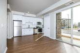 This single-floor residence at 1601 NW 38th St in Kansas City, Missouri offers a clean, contemporary design highlighted by light hardwood flooring, crisp white walls, and an open, airy layout. The living area is bathed in natural light through large sliding glass doors that open to views of the surrounding neighborhood, creating a seamless connection between interior and exterior spaces.

The kitchen is thoughtfully designed with sleek white cabinetry, dark countertops, a classic subway tile backsplash, and a full suite of stainless steel appliances including a refrigerator, range, and over-the-range microwave. A tall window beside the range further brightens the space and adds to the sense of openness.

A stylish barn-style sliding door provides access to a private room featuring carpeted flooring, offering a soft contrast to the hardwood found throughout the main living areas. The bathroom is appointed with a dark granite countertop, an undermount sink, white cabinetry, and a tiled walk-in shower with grab bar, combining functionality with modern aesthetics.

Throughout the unit, recessed lighting, clean lines, and a neutral color palette work together to create a bright, welcoming ambiance well-suited to contemporary living in the heart of Kansas City.