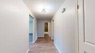 Located at 249 Lowrey Pl in Newington, CT, this single-floor, 2-bedroom, 1-bathroom unit offers a thoughtfully updated interior with a cohesive, modern aesthetic throughout. Wood-style luxury vinyl flooring runs continuously across all rooms, lending visual consistency and easy maintenance.

The open kitchen and living area form the heart of the unit. The kitchen is outfitted with white shaker cabinetry, granite countertops, stainless steel appliances including a refrigerator, gas range, microwave, and dishwasher, and a tile backsplash. The adjacent living area receives natural light through a sliding glass door fitted with vertical blinds, alongside a wall-mounted AC unit and baseboard heating.

A central hallway connects the living space to the two bedrooms and bathroom. The primary bedroom is a well-proportioned room featuring a window with outdoor views, baseboard heating, and dark wood-style flooring. The second bedroom also includes a window, baseboard heating, and a double sliding-door closet.

The bathroom is notably updated, featuring large-format stone-look floor tile, a bold textured tile surround in the tub/shower, a dark vanity with a white basin, an oval mirror, and brushed nickel fixtures.