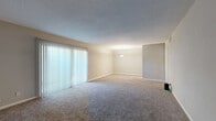 Located at 3876 Northside Drive in Macon, GA, this single-story, 3-bedroom, 2-bathroom home offers a functional and comfortable layout. The expansive living room is a standout feature, showcasing neutral-toned carpet, a textured ceiling, and a large sliding glass door dressed with vertical blinds that floods the space with natural light. A pendant light fixture adds a refined touch to the dining area adjacent to the living space.

The kitchen features wood-look luxury vinyl plank flooring, crisp white cabinetry, light stone-finish countertops, and black appliances including a refrigerator and dishwasher. A window above the sink provides natural light and outdoor views.

All three bedrooms are finished with plush carpet and neutral wall tones, offering a calm and restful atmosphere. The generously sized primary bedroom provides ample space for comfortable living. Each bedroom benefits from window access, bringing in natural light.

The two full bathrooms are clean and functional, each featuring a tiled tub-and-shower combination with chrome fixtures. Wood-look flooring and white cabinetry carry through into the bathroom spaces, maintaining a cohesive aesthetic. A hallway connects the bedrooms and bathrooms, with closets providing convenient storage throughout the home.