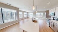 This 1160 sq ft apartment offers a spacious and contemporary living experience. The open-concept design seamlessly integrates the kitchen, living, and dining areas, creating a fluid and functional space. Large windows flood the rooms with natural light and provide panoramic city views. The kitchen boasts sleek white cabinetry, stainless steel appliances, and a convenient island. Both bedrooms are generously sized, with the primary bedroom measuring 180 sq ft. The two full bathrooms feature modern fixtures and finishes, including wood-look flooring and tiled shower enclosures. Additional amenities include ample closet space and a ceiling fan for comfort.