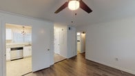 This single-story 2-bedroom, 1-bathroom home offers a thoughtfully designed layout with modern updates throughout. The main living areas feature rich hardwood-style flooring, crisp white walls, and crown molding that add a clean, polished aesthetic. Ceiling fans are present in multiple rooms, providing both comfort and a classic touch. Natural light filters in through blinded windows, brightening each space.

The kitchen is a standout feature, showcasing white shaker-style cabinetry, granite countertops, stainless steel appliances including an electric range with over-the-range microwave, and a dishwasher. A decorative pendant light adds a stylish finishing detail.

The two bedrooms offer distinct flooring choices — one with hardwood-style floors and dual windows for ample natural light, while the second features plush carpeting and includes a walk-in closet for generous storage. Both rooms are equipped with ceiling fans.

The full bathroom is well-appointed with white cabinetry, granite countertops, a dark wood-framed mirror, and a tub/shower combination. A small window provides ventilation and natural light.

Overall, this home presents a clean, move-in-ready environment with updated finishes and a practical, comfortable layout suited for a variety of lifestyles.