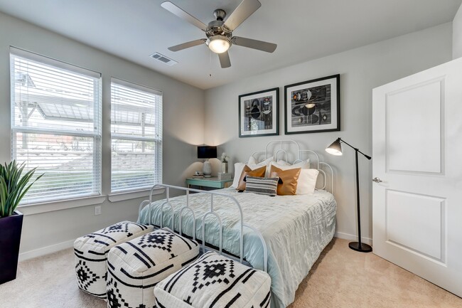 Primary bedroom with plush carpet and ceiling fan - Hardy Oak