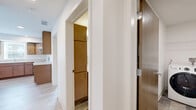 Located at 1591 Hartwell Dr in Carver, MN, this single-floor 2-bedroom, 2-bathroom residence offers a well-organized layout designed for comfortable everyday living. The combined kitchen and living room serves as the heart of the home, featuring warm-toned wood cabinetry, light quartz-style countertops, a kitchen island, white appliances including a dishwasher and range, and recessed lighting. Light wood-look flooring runs throughout the main living areas, lending a clean and contemporary feel.

Both bedrooms are carpeted and receive natural light through windows overlooking the surrounding neighborhood. The primary bedroom is generously sized and includes a walk-in closet equipped with wire shelving for organized storage. The second bedroom also offers ample space with its own closet access. Warm wood-toned doors are featured throughout, adding a consistent design element across the unit.

Each bathroom is finished with slate-style tile flooring, a wood-cabinet vanity, white countertops, and a walk-in shower. A dedicated laundry room houses a full-size GE front-loading washer and dryer set, along with overhead wire shelving for additional storage. A utility room and additional closet space round out this thoughtfully designed, move-in-ready home.