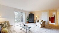 Located at 801 Sherwood Lake Drive in Schererville, Indiana, this well-appointed one-bedroom, one-bathroom residence offers a comfortable and efficiently designed single-floor layout. The open living and dining area serves as the heart of the home, featuring plush carpeting, neutral-toned walls, and a bold green accent wall that adds a touch of personality. Large sliding glass doors flood the living space with natural light and provide direct access to a private balcony overlooking a lush, tree-lined outdoor setting. The dining area accommodates an intimate table setting and connects seamlessly to the galley-style kitchen, which is outfitted with warm honey-toned cabinetry, white appliances, ample counter space, and a dedicated pantry closet for additional storage. The bedroom is a serene retreat, offering carpeted flooring, a bright window with outdoor views, and a walk-in closet with built-in shelving. The full bathroom features a wood-toned vanity with generous cabinet storage, a wide mirror with overhead lighting, tile flooring, and a tub-shower combination. Three closets throughout the home ensure plentiful storage. The overall ambiance is warm, bright, and inviting, making this a practical and comfortable residence.
