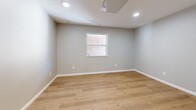 Located at 600 Sherman in Akron, Ohio, this efficiently designed single-floor unit offers a clean, modern aesthetic with thoughtful updates throughout. The open layout maximizes usable space, with warm-toned luxury vinyl plank flooring running continuously through the main living area and kitchen, creating a cohesive and inviting atmosphere.

The kitchen is a functional highlight of the unit, featuring white shaker-style cabinetry — both upper and lower — paired with light granite countertops and a stainless steel single-basin sink. Stainless steel appliances, including a refrigerator, electric range, and over-the-range microwave, provide a polished, contemporary feel. The kitchen opens directly into the living area, which benefits from recessed lighting and a window that brings in natural light.

The bathroom is well-appointed with a white vanity cabinet topped with a bright countertop, a framed mirror with overhead lighting, a full tub-shower combination, and light wood-tone flooring that ties seamlessly into the rest of the unit. Clean white fixtures throughout give the bathroom a crisp, fresh appearance.

Neutral gray walls, white trim, and recessed lighting across the unit contribute to a bright, modern ambiance, making this a well-maintained and move-in-ready space.