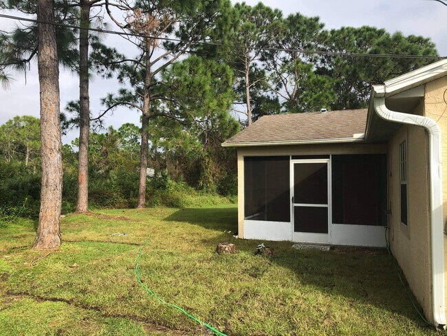 Back yard and look at screened in back porch - 107 Dahl Ave