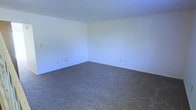 This two-floor residential space presents a straightforward and functional layout designed to accommodate a variety of living arrangements. The interior is finished with a neutral color palette throughout, featuring crisp white walls that create a bright and airy atmosphere, complemented by wall-to-wall carpeting that adds warmth and comfort underfoot.

The rooms are generously proportioned, offering ample space for furnishing and personalization. The clean, uncluttered design provides a blank canvas, making it easy to envision a wide range of interior setups. Electrical outlets are thoughtfully positioned along the baseboards, ensuring convenient access throughout the rooms.

The two-story configuration allows for a natural separation of living and private spaces, offering both functionality and flexibility. The overall ambiance is calm and understated, with the light-toned walls working to maximize the sense of openness in each room.

Whether used as a primary residence or otherwise, this space delivers a solid foundation with its clean finishes, carpeted flooring, and well-maintained interior. The multi-level design adds dimension and practicality, making it a versatile option for those seeking a move-in ready environment with room to make it their own.
