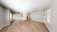 Located in Hollywood at 1318 N Mansfield Ave, this one-bedroom, one-bathroom unit offers a thoughtfully laid-out single-floor plan designed to maximize every square foot. The open living and dining area greets you upon entry, featuring warm wood-style flooring, neutral gray walls, and large windows with slatted blinds that invite abundant natural light. A ceiling fan adds comfort to the living space, which flows seamlessly into the kitchen through a charming arched doorway. The kitchen is well-appointed with white shaker cabinetry, gray countertops, and a full suite of stainless steel appliances including a gas range, built-in microwave, and refrigerator. The bedroom offers a comfortable footprint, natural light via windows, a wall-unit air conditioner, and a mirrored sliding-door closet that enhances the sense of space. The bathroom features wood-style flooring, a white vanity with gray countertops, and a full tub-shower combination. Throughout the unit, clean white trim, consistent flooring, and a neutral color palette create a cohesive and move-in-ready aesthetic ideal for those seeking a functional home in a prime Los Angeles location.