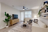 Located in Goodyear, Arizona, this one-bedroom, one-bathroom residence offers a thoughtfully designed single-floor layout with a clean, contemporary aesthetic throughout. Light wood-look flooring and a neutral color palette create a cohesive and inviting atmosphere from room to room.

The open-concept living and kitchen area serves as the heart of the home. The kitchen is outfitted with warm wood cabinetry, stainless steel appliances, a dishwasher, and a central island with a white quartz countertop, undermount sink, and seating for multiple guests — ideal for both everyday use and entertaining. Pendant lighting above the island adds a stylish finishing touch.

The living area is bright and airy, featuring a ceiling fan, sliding door access to the exterior, and a neutral backdrop that suits a variety of décor styles. Floating shelves along one wall add functional display space and visual interest.

The bedroom offers a comfortable, well-proportioned retreat with a window for natural light. A dedicated closet provides rod hanging space alongside built-in shelving for versatile storage.

The bathroom features light wood-tone cabinetry with a white countertop, an undermount sink with matte black hardware, and a shower-tub combination with a curtain rod. Light flooring ties the room together with the rest of the home's design language.