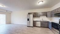 Located at 2004 Prairie Rose Dr in Mankato, MN, this one-bedroom, one-bathroom unit offers a well-designed, single-floor layout that maximizes both comfort and functionality. The open-concept kitchen and living area serves as the heart of the unit, featuring light wood-look vinyl flooring, rich dark-toned cabinetry, and a full suite of stainless steel appliances including a side-by-side refrigerator with ice and water dispenser, electric range, over-the-range microwave, and dishwasher. Light countertops complement the cabinetry, creating a clean, modern aesthetic throughout. The living area is bright and open, with a sliding glass door fitted with vertical blinds that leads out to a private balcony with outdoor views of the surrounding neighborhood. The bedroom offers plush carpeting, a generous window that brings in natural light, and a dedicated closet with built-in shelving. A second closet provides additional storage elsewhere in the unit. The bathroom is clean and functional, featuring a full tub/shower combination. Convenience is further enhanced by an in-unit laundry area and a separate utility room. Neutral tones and modern finishes throughout create a cohesive, move-in ready living environment.
