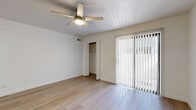 Located at 17239 N 19th Ave in Phoenix, AZ, this single-floor, 2-bedroom, 2-bathroom home offers a clean, modern aesthetic throughout. Light wood-style flooring runs continuously across the space, creating a cohesive and bright interior. The open kitchen and living area serves as the heart of the home, featuring a galley-style kitchen equipped with stainless steel appliances — including a range, microwave, refrigerator, and dishwasher — paired with white cabinetry and stone-finish countertops. The layout flows naturally into the living area, which is bathed in natural light from a sliding glass door that opens to an outdoor patio. Both bedrooms are well-proportioned, each outfitted with a ceiling fan with light fixture and dedicated closet space with built-in shelving and hanging rods. The primary bedroom includes an en-suite bathroom and a large sliding glass door for additional natural light. The two bathrooms are finished with modern vanities featuring stone countertops; one includes a full tub-shower combination. Additional conveniences include an in-unit laundry area, multiple hallway closets for storage, and a practical layout designed for everyday comfort.