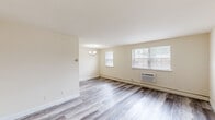Located at 3120 Naamans Rd in Wilmington, Delaware, this well-appointed one-bedroom, one-bathroom unit offers a practical and comfortable single-floor layout. The open combined living and dining area is bright and welcoming, featuring light-toned hardwood-style flooring, cream-colored walls, and multiple windows that allow natural light to fill the space. A chandelier accent light adds a touch of warmth, while a wall-mounted A/C unit and baseboard heating ensure year-round comfort. The galley-style kitchen is efficiently designed with warm honey-toned wood cabinetry lining both sides, laminate countertops, a gas range, dishwasher, and full-size refrigerator — all finished with matching hardwood-style flooring. The bedroom is a comfortable retreat carpeted in neutral tones, with a window for natural light, baseboard heating, and direct access to the full bathroom. The bathroom features white tile flooring, a vanity with mirrored medicine cabinet, a tub-shower combination, and bright overhead lighting. Rounding out this unit are four closets thoughtfully distributed throughout, providing generous storage. The clean, neutral palette and functional layout make this a move-in ready home in a convenient Wilmington location.