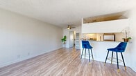 Located at 4444 Hazeltine Ave in the Sherman Oaks neighborhood of Los Angeles, this one-bedroom, one-bathroom unit offers a well-organized single-floor layout with a clean, bright aesthetic throughout. Light wood-style flooring runs continuously across all rooms, complemented by white walls and textured ceilings that add a classic character to the space.

The open-concept living and dining area is generously proportioned, anchored by a ceiling fan and filled with natural light from large windows. A wall-mounted air conditioning unit ensures year-round comfort. The kitchen is efficiently designed in a galley configuration with white cabinetry, granite countertops, a gas range, stainless steel refrigerator, and a breakfast bar with seating — ideal for casual dining.

The bedroom is a comfortable, well-lit room featuring a large window with neighborhood views and a mirrored sliding-door closet that adds depth and reflects natural light. An additional closet provides extra storage. The bathroom includes a full-sized shower-tub combination with clean white surrounds and chrome fixtures.

Two closets throughout the unit offer practical storage solutions. The overall design is functional, light-filled, and move-in ready, making this unit an efficient and comfortable home in a prime Los Angeles location.