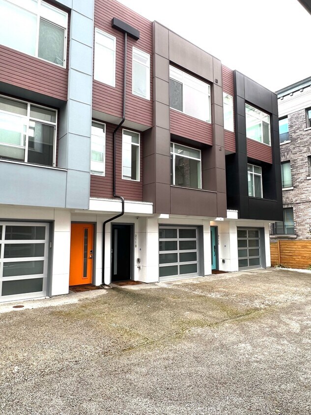 Front door and garage entry. End unit with the blue door. - 211 13th Ave E