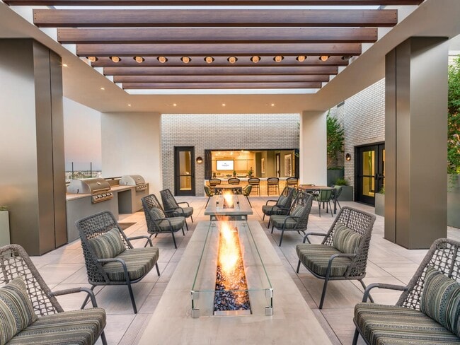Take in the mountain views and relax by the firepits—this rooftop offers a peaceful place to unwind. - Modera Scottsdale