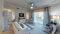Located at 201 River Pointe Dr in Conroe, Texas, this single-floor residence offers a well-organized and cohesive layout designed for comfortable everyday living. Crown molding accents throughout the home add a refined architectural touch, while ceiling fans in the main living and bedroom areas provide both function and style.

The living room is a welcoming space highlighted by a soft blue accent wall, plush carpeting, and large sliding glass doors that open to an outdoor balcony, allowing ample natural light to fill the room. Adjacent to the living area, the dining room features crown molding and a dedicated chandelier overhead, creating an intimate setting for shared meals.

The kitchen is equipped with rich wood cabinetry, a central island with counter seating, track lighting, tile flooring, and a full suite of black appliances including a refrigerator, range, microwave, and dishwasher — offering both practicality and visual warmth.

The primary bedroom features a bold blue accent wall, plush carpeting, a ceiling fan, and direct access to an en-suite bathroom. The second bedroom is bright and airy, with natural light from a large window and soft neutral tones. The full bathroom includes a tub-shower combination, a single-sink vanity with ample counter space, and tile flooring. A dedicated laundry area houses a full-size washer and dryer, adding everyday convenience.