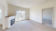 Located at 436 Broadway in downtown Tacoma, Washington, this two-bedroom, one-bathroom unit on the fourth floor offers a well-organized layout across a compact, efficiently designed floor plan. The living room serves as the heart of the unit, featuring plush neutral carpeting, a fireplace, and a sliding glass door that opens to a balcony with open city views of the Tacoma skyline. Natural light fills the space through the large glazed door, creating a bright and inviting atmosphere.

The kitchen is thoughtfully appointed with stainless steel appliances, including a refrigerator, range, and microwave, complemented by white cabinetry, quartz-style countertops, a stainless steel sink, and wood-look flooring. Track lighting overhead enhances functionality in this efficiently arranged space.

Both bedrooms are carpeted and finished in neutral tones. The primary bedroom includes a sliding glass door providing additional outdoor access and natural light, while the second bedroom features a double closet with built-in shelving. A hallway connects the rooms to the shared full bathroom, which is finished with a vessel-style sink, light wood cabinetry, a tub-shower combination, and wood-look flooring, all contributing to a clean, modern aesthetic throughout the unit.