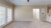 Located at 5402 Garden Lake Dr in Greensboro, NC, this single-floor, three-bedroom, two-bathroom home offers a functional and comfortable layout. The kitchen is a standout feature, showcasing warm wood cabinetry, granite countertops, stainless steel appliances including a range, microwave, dishwasher, and refrigerator, all complemented by light hardwood-style flooring and recessed lighting. Crown molding adds a refined touch to the kitchen and adjoining areas.

The three bedrooms are finished with soft, neutral-toned carpet and ceiling fans, creating a cozy atmosphere. The spacious primary bedroom includes access to a dedicated closet, providing ample storage. Additional bedrooms offer natural light through blinded windows with exterior views of the surrounding landscape.

The two bathrooms are finished with granite-topped wood vanities and light hardwood-style flooring. Each features a tub-shower combination with chrome fixtures, offering clean, practical design. One bathroom is conveniently accessible from the hallway, serving the secondary bedrooms.

The home also includes a dedicated laundry area, a hallway connecting the living spaces, and a closet for additional storage. The consistent warm beige wall tones and white trim throughout create a cohesive, inviting ambiance across all rooms.