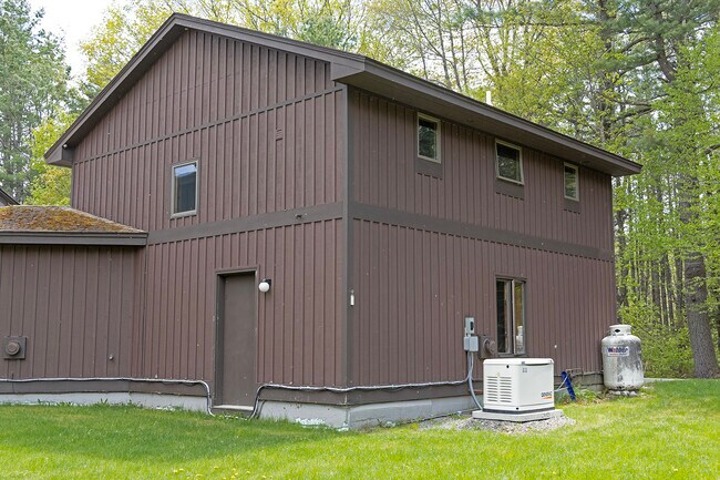 Back of apt with 3 back windows, stairwell window & garage side door (left) - 64 Gardner Rd
