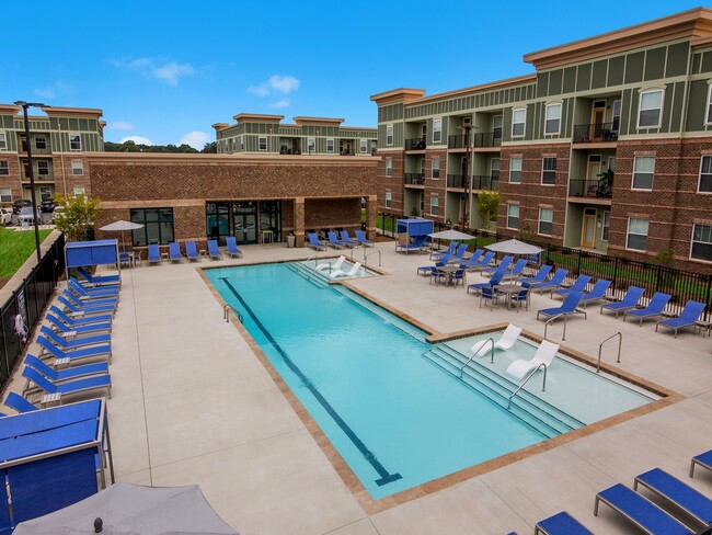 Resort-Style Swimming Pool with Sun Shelf and Fountains During the Day - Ardmore at the Trail