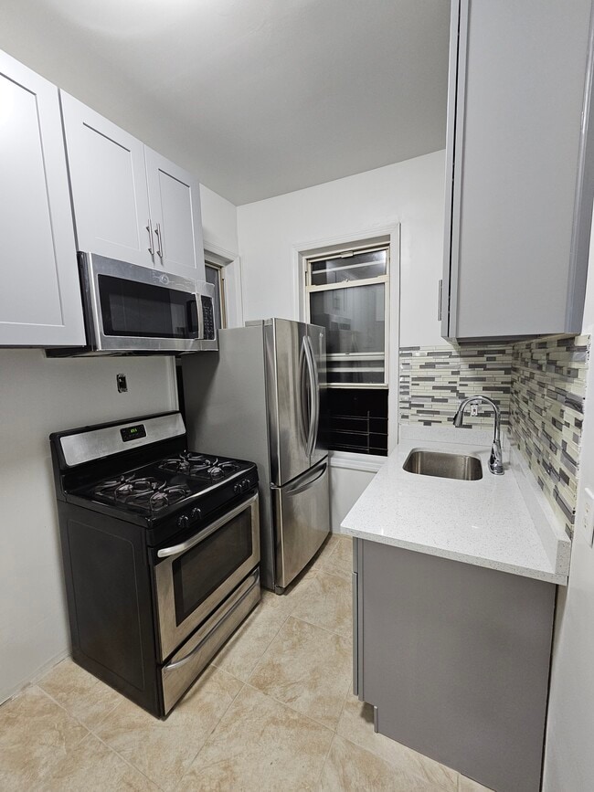 New stainless steel fridge, stove, microwave, and sink - 3720 27th St