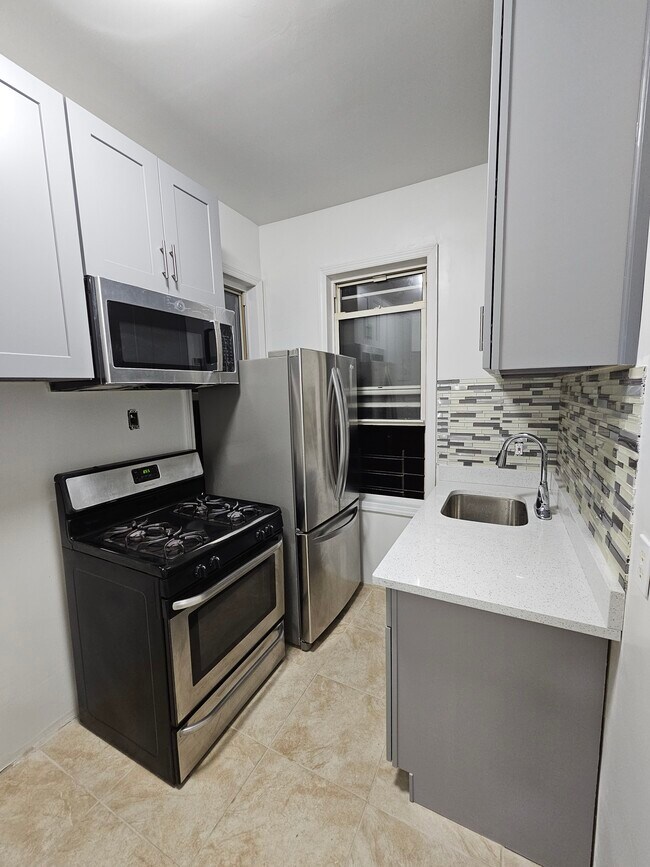 New stainless steel fridge, stove, microwave, and sink - 3720 27th St