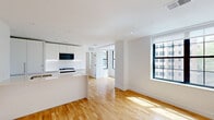 Located in Washington, DC's vibrant Adams Morgan neighborhood, this 2-bedroom, 1-bathroom residence offers a thoughtfully designed open-concept layout finished with clean, modern details throughout. Warm hardwood floors run continuously across the entire unit, complementing the crisp white walls and recessed lighting that create a bright, airy atmosphere.

The combined kitchen and living area forms the heart of the home. The kitchen is outfitted with flat-front white cabinetry extending to the ceiling, a large peninsula with a white quartz countertop and undermount sink, stainless steel gas range, and a built-in microwave — all framed by under-cabinet lighting for a polished finish.

Both bedrooms feature natural light through large black-framed windows that offer views of the surrounding cityscape. The primary bedroom includes two closets, providing ample storage. The second bedroom is a well-proportioned space with its own large window. A connecting hallway leads efficiently between the rooms.

The full bathroom features neutral tile flooring, grey tile wall accents, a glass-enclosed shower, and a window that brings in natural light. The overall design is clean, contemporary, and move-in ready, making this a highly functional urban residence in one of DC's most sought-after neighborhoods.