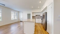 Located in Palm Desert, CA, this 2-bedroom, 1-bathroom residence offers a thoughtfully designed single-floor layout with clean, contemporary finishes throughout. The open-concept living and kitchen area is anchored by light wood-style flooring and a ceiling fan, creating a bright and airy atmosphere. The kitchen is well-appointed with white shaker cabinetry, a classic tile backsplash, stainless steel appliances including a gas range, built-in microwave, dishwasher, and refrigerator, plus a peninsula with quartz countertops that provides additional prep and seating space. The living area flows seamlessly from the kitchen, offering a comfortable and versatile layout. Both bedrooms feature soft carpeting and ceiling fans; the primary bedroom is generously sized with large windows that invite natural light and outdoor views, while a sliding glass door provides direct outdoor access. The secondary bedroom also benefits from ample natural light. A hallway connects the bedrooms to the shared bathroom, which features a white vanity with quartz countertops, modern fixtures, and wood-style flooring. A dedicated closet area offers built-in shelving, and a convenient in-unit laundry space with a full-size washer and dryer completes this well-equipped residence.