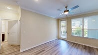 Located on Lake Murray Boulevard in Columbia, SC, this well-appointed one-bedroom, two-bathroom home offers a thoughtfully designed single-floor layout that maximizes comfort and functionality. Light-toned hardwood-style flooring flows consistently throughout the space, complemented by crisp white baseboards and crown molding that lend a polished, cohesive finish to every room.

The open-concept kitchen and living area serves as the heart of the home. The kitchen features rich, dark espresso cabinetry, stainless steel appliances including a refrigerator, range, and microwave, and a granite-topped peninsula with pendant lighting and an integrated sink — ideal for both cooking and casual dining. Track lighting above enhances the workspace.

The living area is bright and airy, with a ceiling fan with light fixture, neutral warm-toned walls, and a glass door alongside a flanking window that invite natural light and outdoor views. Crown molding adds an elegant architectural touch overhead.

The generously sized primary bedroom accommodates a ceiling fan, multiple windows with natural light, and access to a closet. Two full bathrooms serve the home, providing ample convenience. A dedicated in-unit laundry room houses a full-size washer and dryer with overhead shelving for additional storage. The layout is efficient and practical, making excellent use of every square foot.