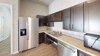 Located at 7156 Barrington Dr in Charlotte, NC, this single-floor residence offers a thoughtfully designed layout with modern finishes and accessibility features throughout. The open-concept kitchen is a functional highlight, showcasing rich dark-espresso cabinetry, light stone-toned countertops, stainless steel appliances including a side-by-side refrigerator and dishwasher, and a stainless steel sink — all set atop durable wood-look flooring that flows consistently through the living areas. The bedrooms are bright and welcoming, each featuring neutral wall tones, light hardwood-style flooring, and windows fitted with blinds that invite natural light while maintaining privacy. One bedroom includes a ceiling fan for added comfort. The bathrooms are designed with accessibility in mind, equipped with grab bars, a single-sink vanity with dark cabinetry and a light countertop, a soaking tub with shower, and clean tile flooring. A separate accessible restroom with safety grab bars adds further convenience. Throughout the residence, clean lines, neutral color palettes, and consistent flooring create a cohesive and inviting atmosphere well-suited for comfortable everyday living.