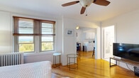 Located at 1936 N Clark Street in Chicago's desirable Lincoln Park neighborhood, this one-bedroom, one-bathroom unit offers a well-utilized layout with classic architectural details throughout. Warm hardwood floors run continuously through the living areas, complemented by crisp white walls and crown molding that add a timeless character to the space.

The generously sized bedroom serves as the heart of the unit, featuring a ceiling fan, multiple windows dressed with wood-slat blinds, and views of the surrounding parkland and Lake Michigan beyond — a standout feature that fills the room with natural light. The bedroom flows openly into the dining area, which offers a cozy, defined space ideal for everyday meals. The kitchen is efficiently laid out with white cabinetry, a gas range, and full-size refrigerator, providing all essential amenities in a compact footprint.

The bathroom is cleanly finished with white tile flooring, a granite-topped vanity with under-sink storage, a mirrored medicine cabinet, and a shower/tub combination. Throughout the unit, the design prioritizes functionality while maintaining a bright, airy ambiance. Situated directly across from Lincoln Park and steps from Lake Michigan, this unit benefits from an exceptional urban location with abundant green space and lakefront access nearby.