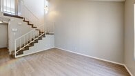 Located in Lancaster, CA, this two-story home offers a thoughtful layout spread across two well-proportioned floors. The main level features a bright entryway with vaulted ceilings and large windows that flood the space with natural light, flowing into an open living area with light wood-style flooring and a ceiling fan. The kitchen is well-appointed with white cabinetry, granite-style countertops, a gas range, a double sink, and a skylight that adds additional brightness. A carpeted staircase connects the floors. Upstairs, the generously sized primary bedroom features tall ceilings, soft carpet, and direct access to a private en-suite bathroom with a walk-in shower and a vanity with stone-style countertops. The second bedroom offers comfortable proportions, a built-in window seat, natural light, and a sliding-door closet. Three full bathrooms across the home include both a tub/shower combo and stand-alone shower configurations. The attached garage features an epoxy-coated floor and an automatic garage door opener, providing practical storage and parking. The home's neutral color palette and clean finishes create a cohesive, move-in-ready ambiance throughout.
