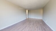 Located at 105 Cherryhill Blvd in London, Ontario, this well-appointed one-bedroom, one-bathroom unit offers a thoughtfully designed layout with modern updates throughout. Light-toned laminate flooring flows seamlessly across the entire space, creating a cohesive and clean aesthetic.

The living room is a standout feature, bathed in natural light through expansive floor-to-ceiling sliding glass doors that open to a private balcony overlooking mature trees and the surrounding neighbourhood. The open, airy feel of this room makes it an inviting space to relax or entertain.

The galley-style kitchen is efficiently designed with crisp white cabinetry, stone-look countertops, a subway tile backsplash, and stainless steel appliances including a refrigerator and range. Ample upper and lower cabinet storage ensures generous functionality.

The spacious primary bedroom comfortably accommodates large furnishings and is brightened by a sizeable window. Multiple interior doors suggest convenient closet access within the room.

The bathroom is clean and classic, featuring a full soaker tub with shower, white tile surround, and overhead cabinetry for additional storage. Neutral tones throughout the unit contribute to a bright, welcoming ambiance that is move-in ready.