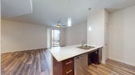 This contemporary 900 square foot apartment in Austin, TX offers a harmonious blend of style and functionality. The open-concept design seamlessly integrates the kitchen and living areas, creating an inviting space for both relaxation and entertainment. The kitchen boasts sleek stainless steel appliances, dark wood cabinetry, and a practical breakfast bar.

The apartment features three bedrooms, including a spacious 170 square foot primary bedroom, all equipped with ceiling fans for comfort. Three full bathrooms provide convenience and privacy. The living areas showcase attractive wood-look flooring, while bedrooms are carpeted for a cozy feel.

Large windows throughout allow for ample natural light, enhancing the airy ambiance. The apartment includes a generously sized walk-in closet with built-in organizers, offering abundant storage solutions. Modern fixtures, such as track lighting in the kitchen and stylish ceiling fans, add to the overall aesthetic.

The bathroom areas feature clean, white tiled surfaces and contemporary fixtures. The apartment's neutral color palette provides a versatile backdrop for various decor styles. With its thoughtful layout and quality finishes, this apartment presents an ideal living space in the heart of Austin.