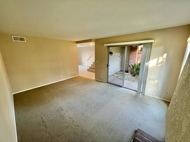Building Photo - Lush grounds surround this townhouse in a ...