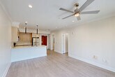 Located at 4650 Washington Ave in New Orleans, LA, this modern 1-bedroom, 1-bathroom unit offers a thoughtfully designed single-floor layout. Light wood-look flooring flows consistently throughout, creating a clean, cohesive aesthetic.

The open-concept living, dining, and kitchen area serves as the heart of the unit. The kitchen is well-appointed with light wood cabinetry, white quartz countertops, a peninsula with a double undermount sink, and a full suite of stainless steel appliances including a refrigerator, range, microwave, and dishwasher. Sleek black pendant lights hang above the peninsula, complementing the recessed ceiling lighting. A ceiling fan adds comfort to the living area, which opens via sliding glass doors to a private patio with outdoor views.

The spacious primary bedroom features crown molding, a ceiling fan, a large window with natural light, and ample closet space. The full bathroom offers a wood-tone vanity with a sink, a tiled tub/shower combination with sliding glass doors, and wood-look tile flooring. Additional conveniences include a dedicated laundry area and hallway storage. The unit presents a bright, contemporary feel throughout with a neutral color palette and modern finishes.