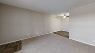 Located at 415 NE Delaware Ave in Ankeny, Iowa, this one-bedroom, one-bathroom unit offers a well-organized, single-floor layout designed for comfortable everyday living. The living room serves as the heart of the space, featuring soft wall-to-wall carpeting, neutral beige walls, and a textured ceiling. A ceiling fan provides overhead lighting and air circulation, while the transition to wood-style flooring in the adjacent area adds a subtle contrast in materials and defines the space naturally.

The bedroom is a comfortably sized retreat with plush carpeting, neutral tones, and a large window that invites natural light and provides views of the surrounding exterior. White trim and clean lines throughout contribute to a bright, cohesive aesthetic. A dedicated closet offers convenient storage directly off the bedroom.

The bathroom is straightforward and functional, featuring a full-size soaking tub with a tub/shower surround, a toilet, and wood-style flooring that complements the rest of the unit. The clean white fixtures stand out against the neutral wall tones, creating a tidy and practical space.

Overall, the unit maintains a consistent palette of warm neutrals and clean whites, offering a move-in-ready environment that is easy to personalize. The efficient layout makes practical use of every area, making this a solid and well-appointed living space in Ankeny.